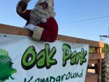 Santa waving from inside the Oak Park Kampground wagon